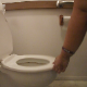 One of our users records his large wife taking a shit into a toilet while bending over. We get to see her mess in the toilet bowl afterwards. About a minute.